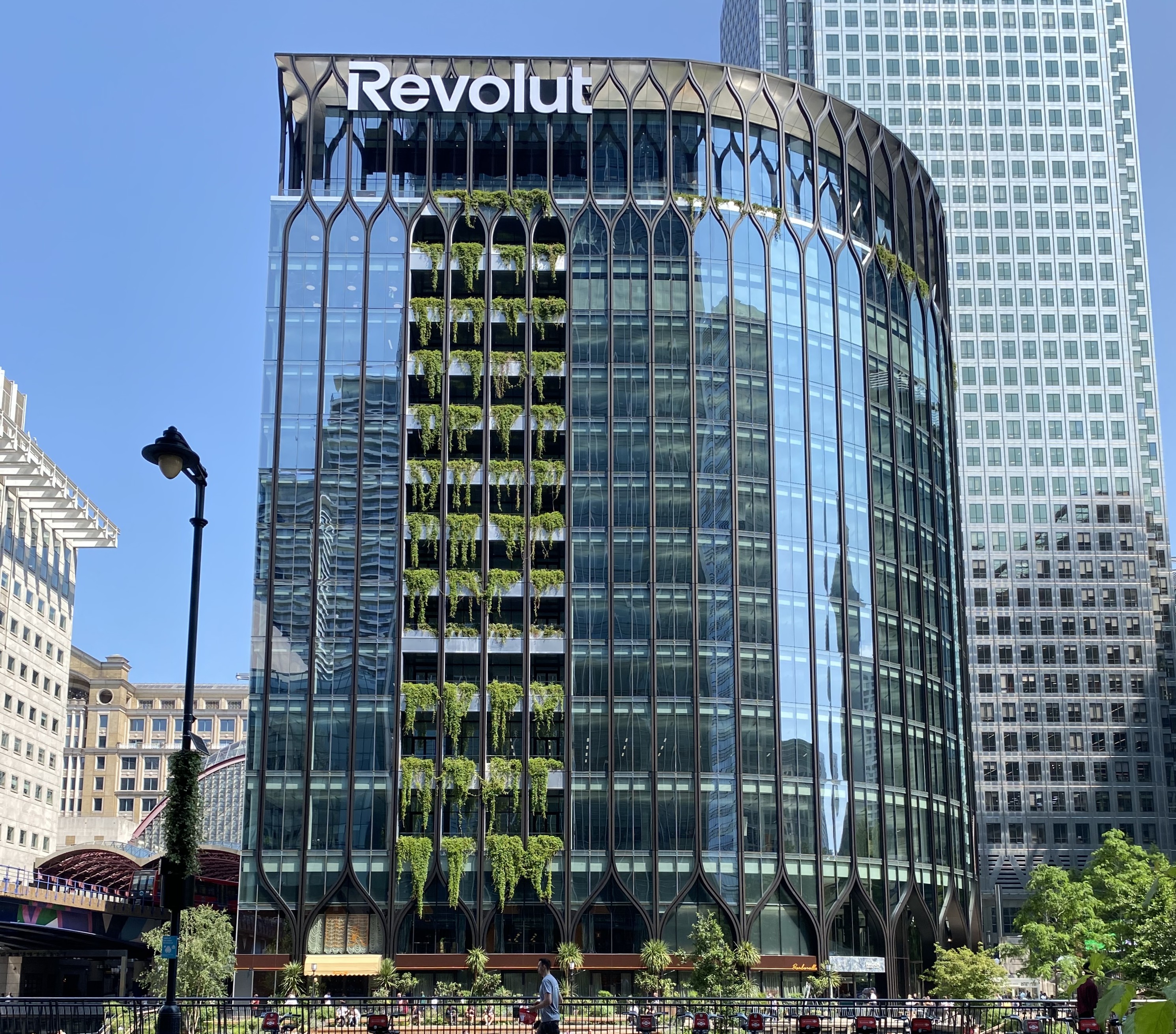 Glass facade of Revolut’s headquarters in Canary Wharf, London, with the company sign. Illustrative photograph taken June 19, 2025.